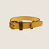 A handcrafted dog collar in a wheat-yellow hue features a sturdy design with a brass buckle and a brown leather accent. The collar showcases a sleek, minimalist style, ideal for complementing any dogs coat.