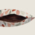 A close-up view of an open pouch featuring a light-colored fabric adorned with colorful leaf patterns in shades of rust, green, and beige. The interior of the pouch is lined with a dark brown material, showcasing a zipper closure.