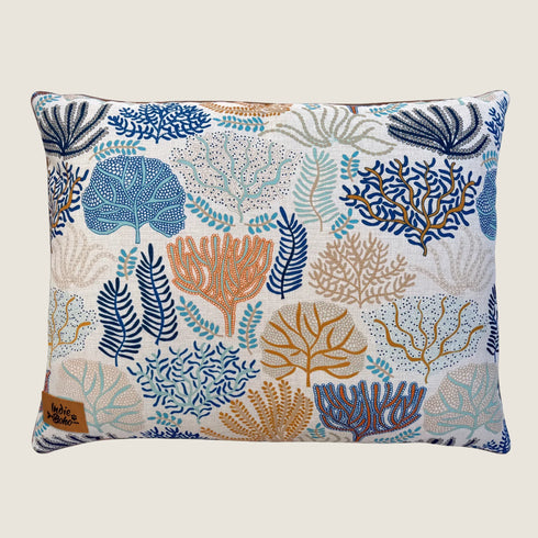 A decorative throw pillow featuring a vibrant coral and leaf pattern in shades of blue, orange, and cream. The intricate designs are set against a light background, adding a touch of nature-inspired elegance to any space.