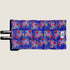 A vibrant dog travel mat featuring a bold floral pattern with purple flowers, red accents, and green foliage set against a rich blue background. The mat is designed with straps for easy carrying and is perfect for outdoor adventures.