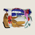 A rolled-up travel mat featuring vibrant illustrations of Australian wildflowers and plants, secured with white straps. The mat displays a colorful design on a pale yellow background, showcasing a blend of reds, greens, and blues.