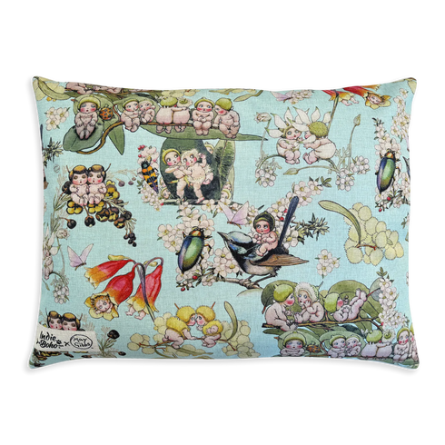 A decorative pillow featuring a whimsical, colorful print with illustrations of cherubic figures, birds, and flowers against a light blue background. The design combines elements of fantasy and nature, adding a playful touch to any space.