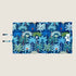 A vibrant dog travel mat featuring a bold coastal pattern with blue, green, and orange hues. The design showcases various stylized palm trees and tropical plants, emphasizing a lively and playful aesthetic.