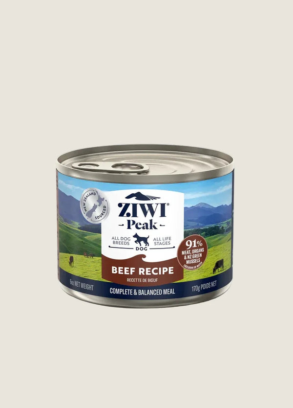 A can of ZIWI Peak Beef Recipe dog food is displayed against a plain background. The label highlights that it contains 91% meat, is suitable for all dog breeds and life stages, and emphasizes the use of ethical, grass-fed beef.