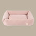 A soft blush corduroy pet bed with a rectangular shape and plush, padded edges. The bed features a removable cover for easy cleaning, showcasing a luxurious.